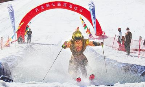 5月1日，萬(wàn)龍滑雪場(chǎng)第七屆“百龍過(guò)江”活動(dòng)現(xiàn)場(chǎng)，一名選手滑過(guò)水池。