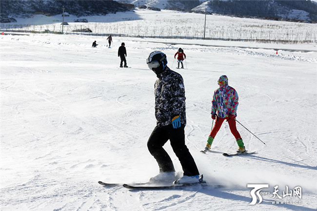 在白云國(guó)際滑雪場(chǎng)內(nèi),雪友們正在初級(jí)道上滑雪。